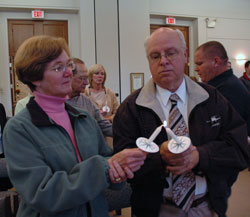 St. Malachy parishioners Cathy and Robert Weidenbener of Brownsburg light their candles during the All Souls Day Mass celebrated by Msgr. Joseph F. Schaedel, vicar general, on Nov. 2 at the Our Lady of Peace Mausoleum Chapel in Indianapolis.