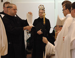 Benedictine Brother Christian Raab presents his vow chart to Archabbot Justin DuVall during a liturgy on Jan. 25 at the Archabbey Church in St. Meinrad. Brother Christian professed solemn vows during the liturgy, and became a full and permanent member of Saint Meinrad Archabbey. (Submitted photo)	