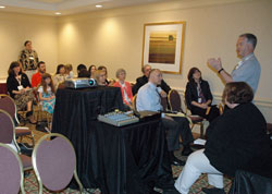 Msgr. Paul Tighe, right, secretary for the Vatican’s Pontifical Council for Social Communications, discusses blogging during an impromptu meeting on June 23 at the Catholic Media Convention in Pittsburgh. Blogger Elizabeth Scalia, seated at right, also spoke during the meeting. (Photo by Sean Gallagher)