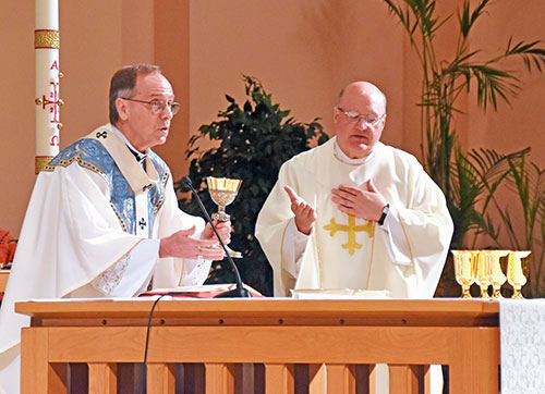 Msgr. William F. Stumpf, archdiocesan vicar general, right, joins Archbishop Charles C. Thompson in praying the eucharistic prayer at a Mass at SS. Peter and Paul Cathedral in Indianapolis on May 9 as part of the annual Circle of Giving event. (Photo by Natalie Hoefer)