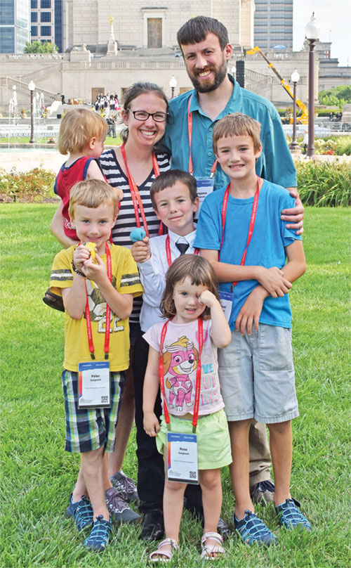 Leigh and Benjamin Sargeant and their five children—Rose in front with Peter (left), Dominic and Samuel behind her, and Isaiah, held by Leigh—pose in Memorial Plaza in Indianapolis on July 20 after worshipping the Blessed Sacrament with more than 50,000 people during the National Eucharistic Congress. The day marked the couple’s 11th wedding anniversary. (Photo by Natalie Hoefer)