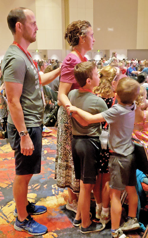 A family lays their hands on each other in prayer as part of a family-focused session on July 19 during the National Eucharistic Congress in Indianapolis. (Photo by Natalie Hoefer)
