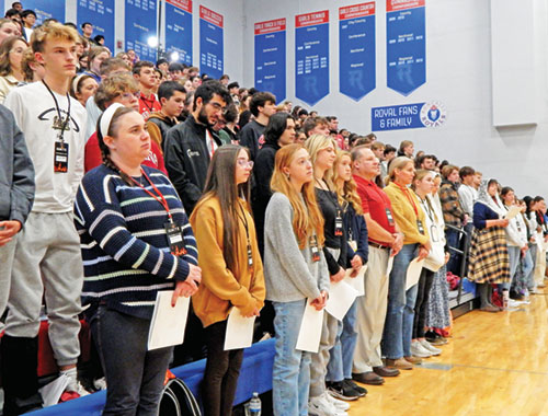 Teenagers and adults stand at the beginning of Mass during an Ignite event on Nov. 24 at Roncalli High School in Indianapolis. More than 450 teens and adult volunteers attended the daylong high school retreat. (Photo by Mike Krokos)