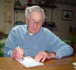 Othmar “Ottie” Mathias draws a sketch of Dachau, a Nazi concentration camp in Bavaria, Germany, that his army unit liberated in April of 1945. (Message photo by Mary Ann Hughes)